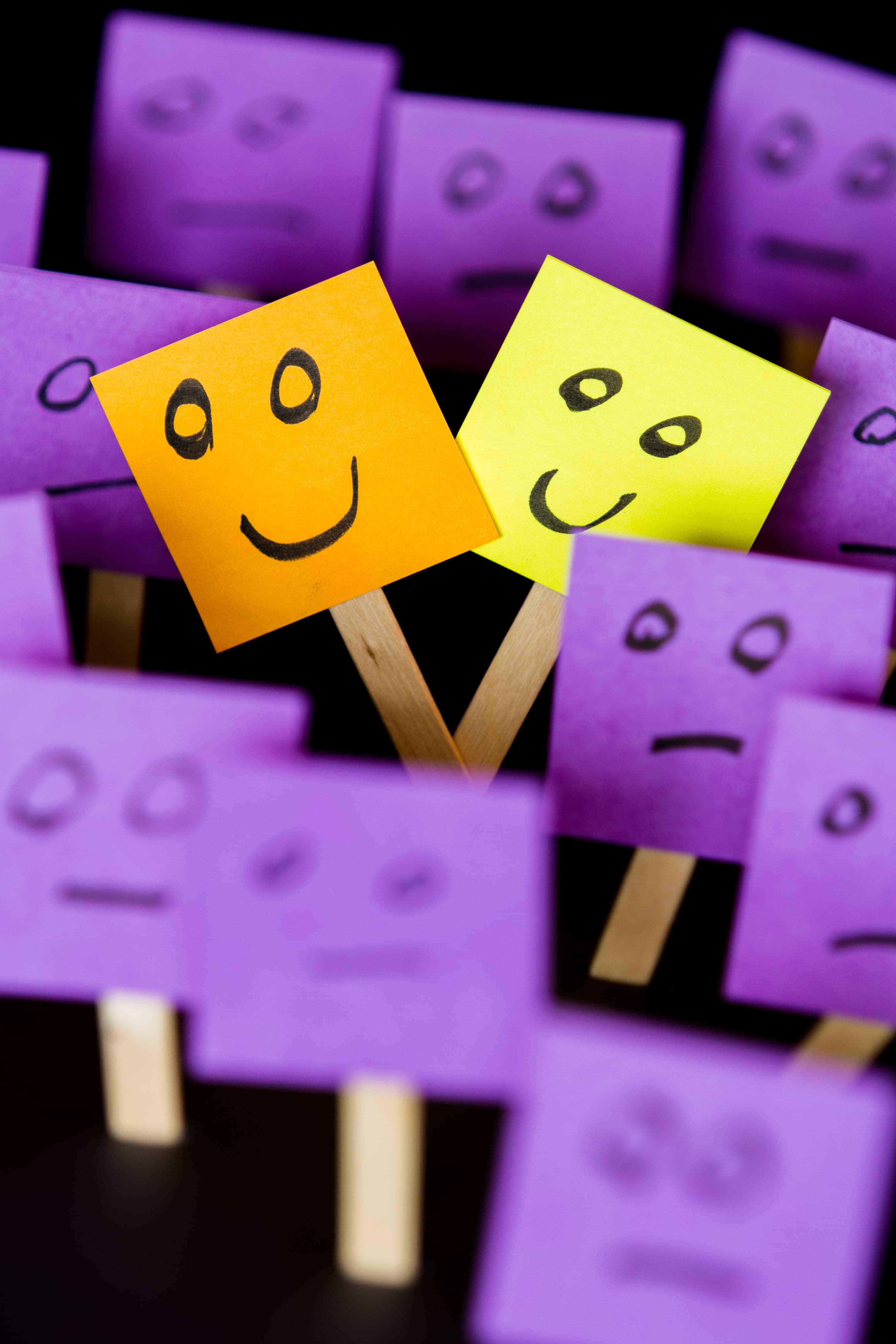 Sticky notes with smiling faces drawn on them
